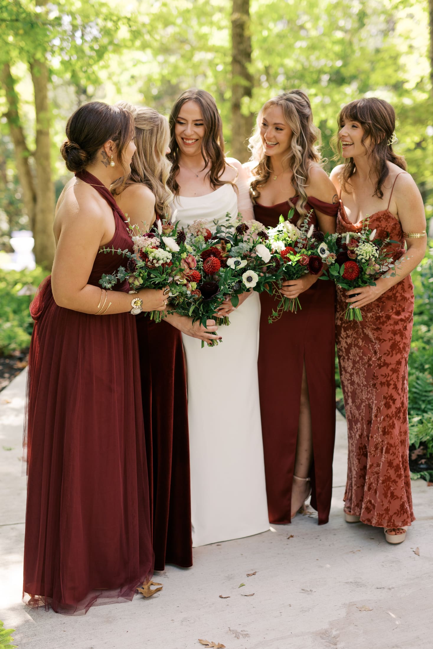 Bride surrounded by bridesmaids after hair and makeup