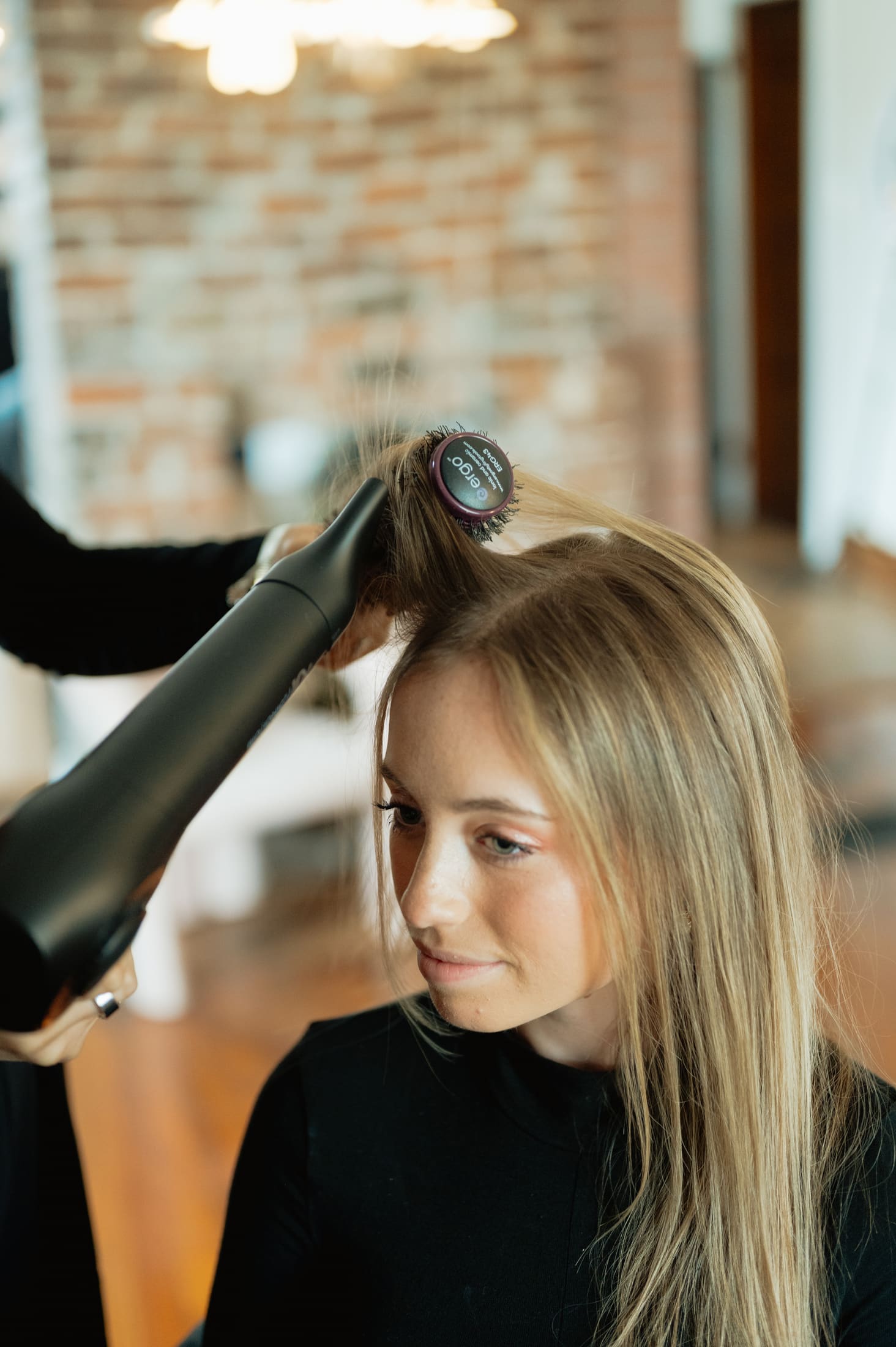 Stylist blow-drying a bride’s hair